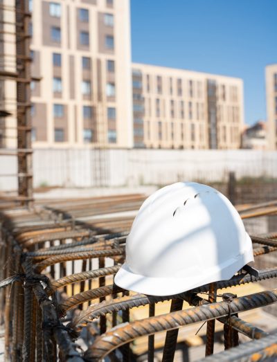 White hard hat on fittings at construction site.